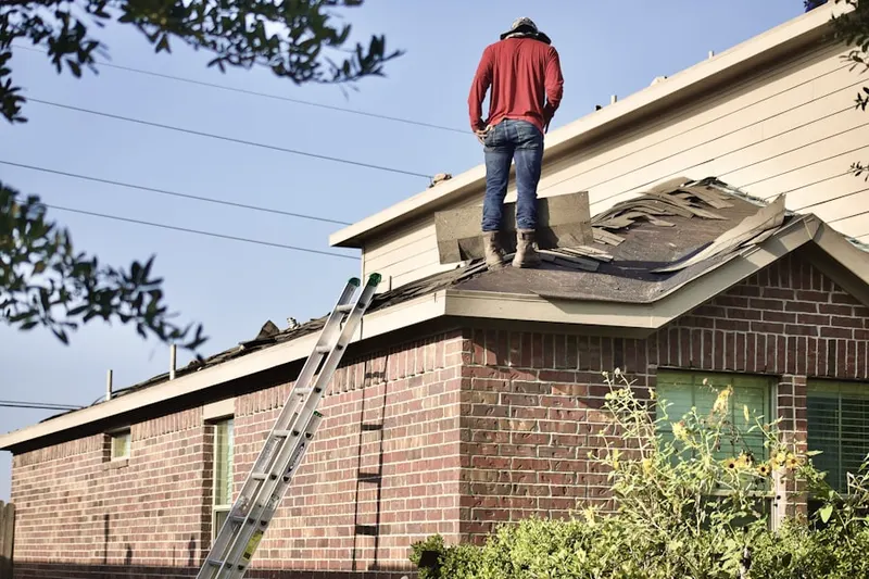 Professional roofer working on a residential roof in Palm Springs Country Club Estates